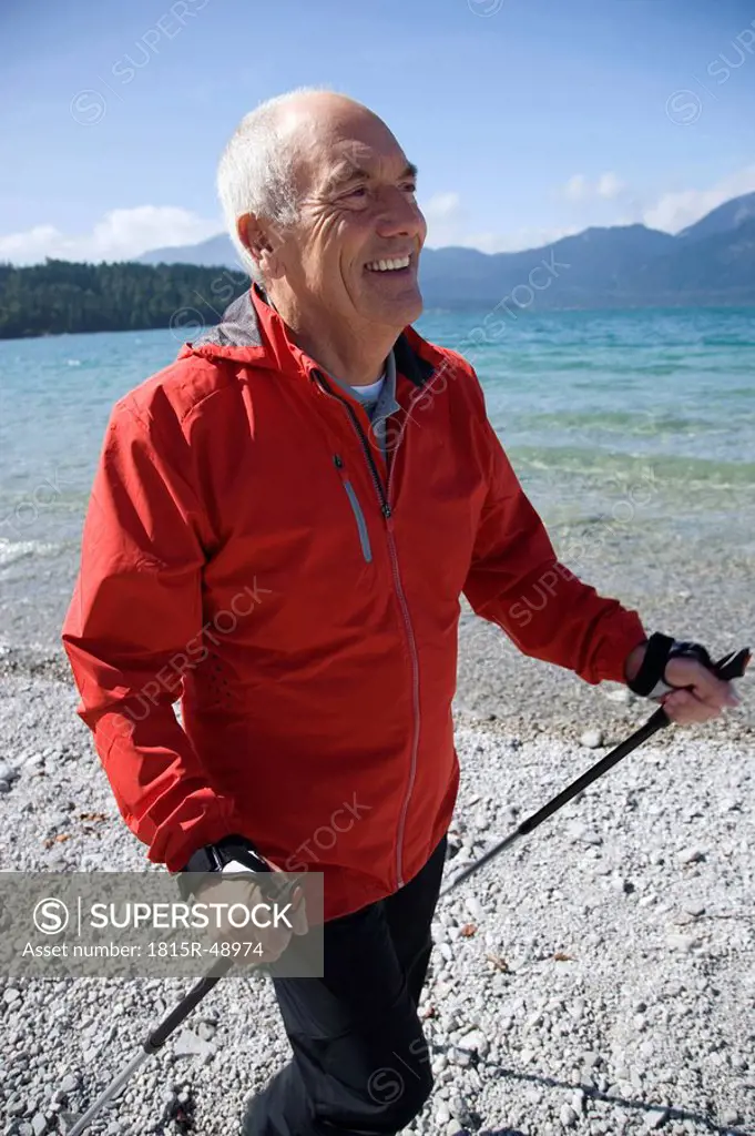 Germany, Bavaria, Walchensee, Senior man with walking sticks