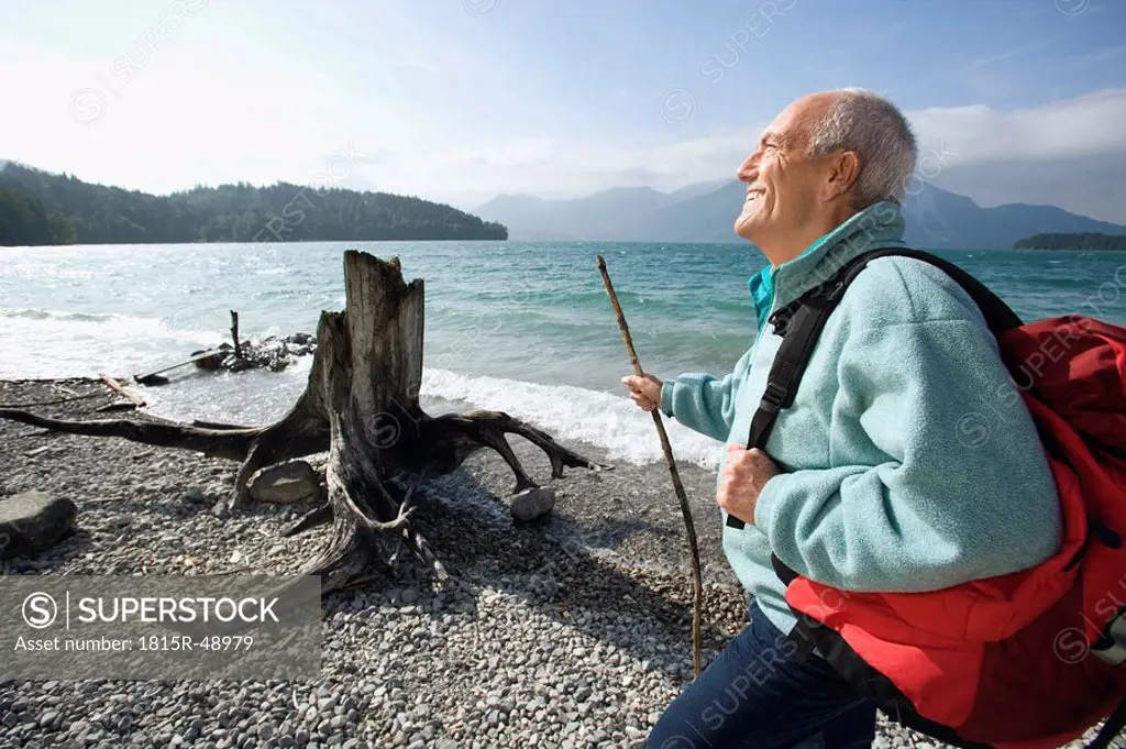 Germany, Bavaria, Walchensee, Senior man taking a break on lakeshore