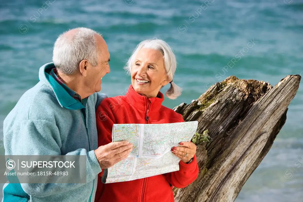 Germany, Bavaria, Walchensee, Senior couple looking at map