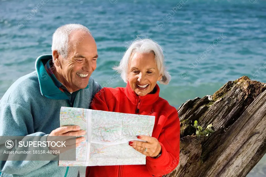 Germany, Bavaria, Walchensee, Senior couple looking at map
