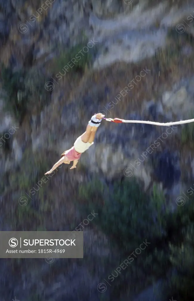 Young woman bungee jumping