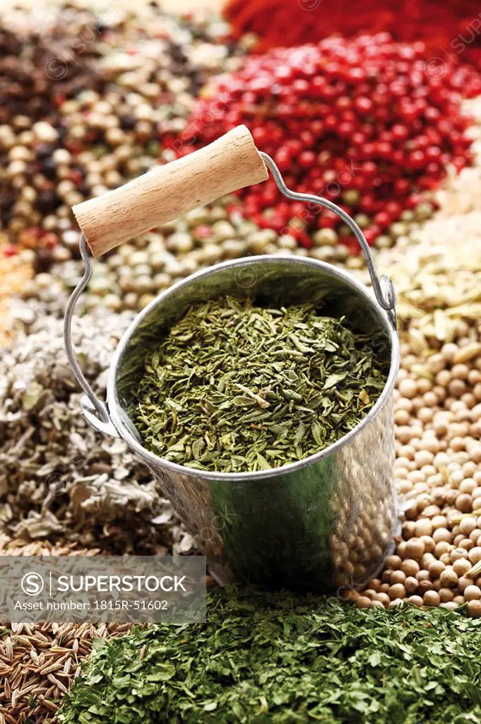 A selection of spices, in foreground dried sage in zinc bucket, close_up
