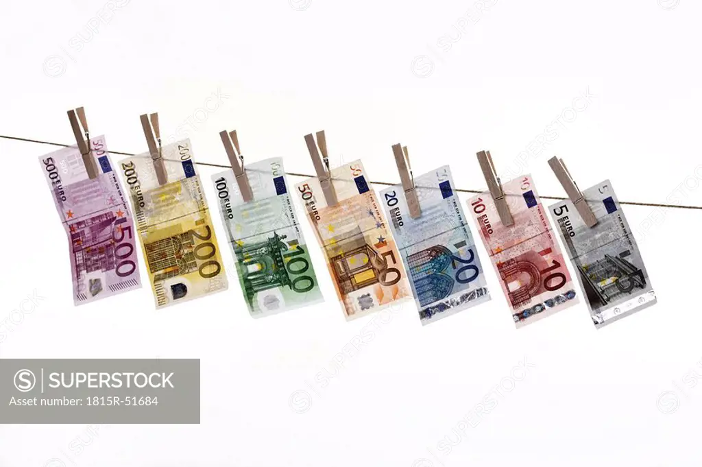 Different Euro bank notes hanging on clothesline