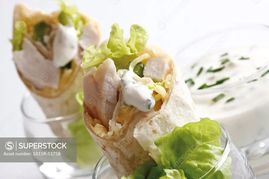 Chicken Wraps in glasses and Yoghurt dip in glass, close_up