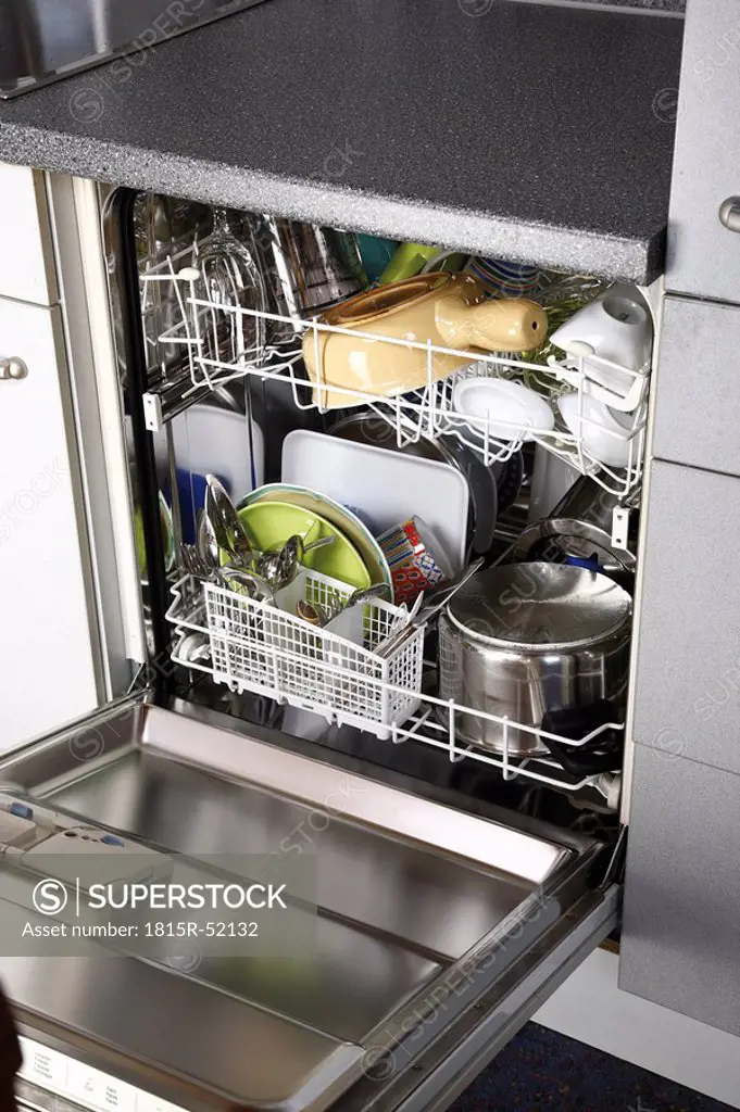 Cleaned dishes in open dishwasher,