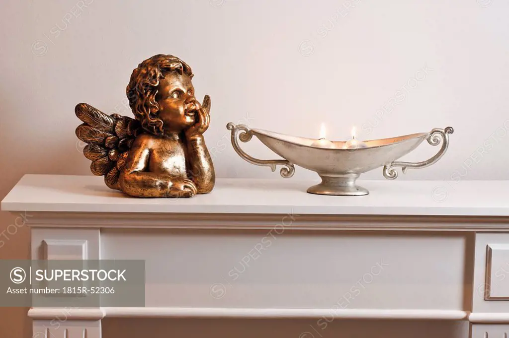Angel figurine and decoration on shelf