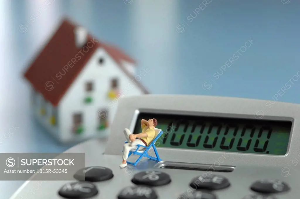 Plastic figurine on calculator keyboard, close_up