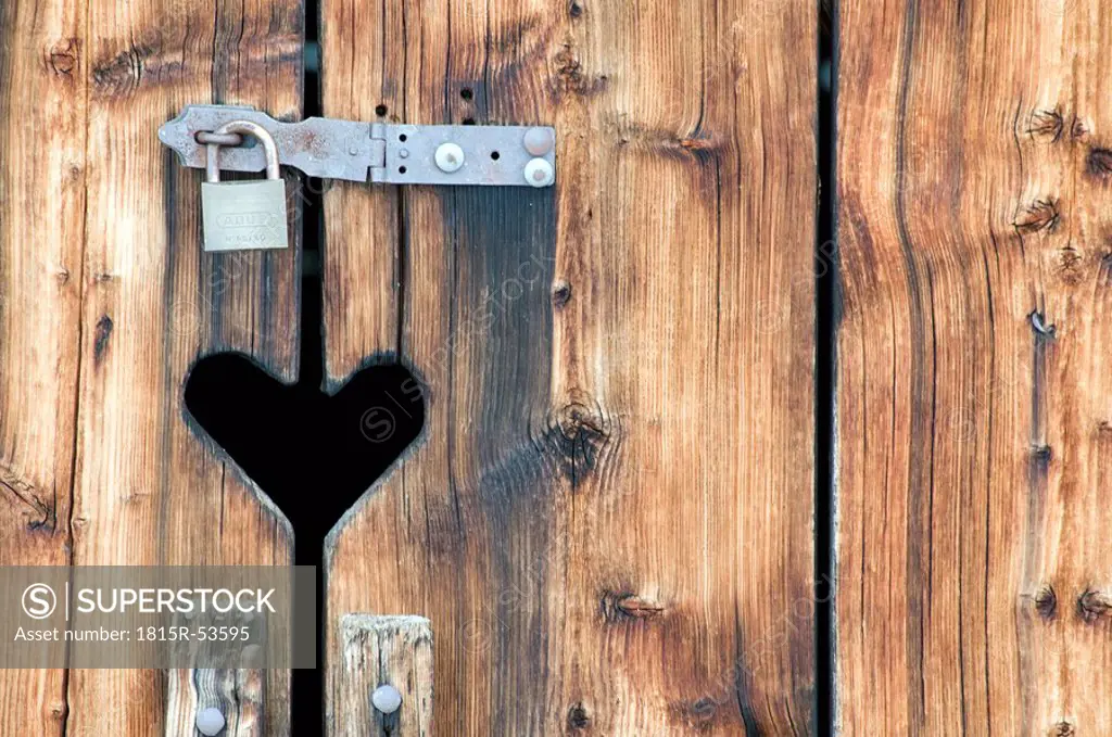 Switzerland, Arosa, Heart symbol on wooden door with padlock