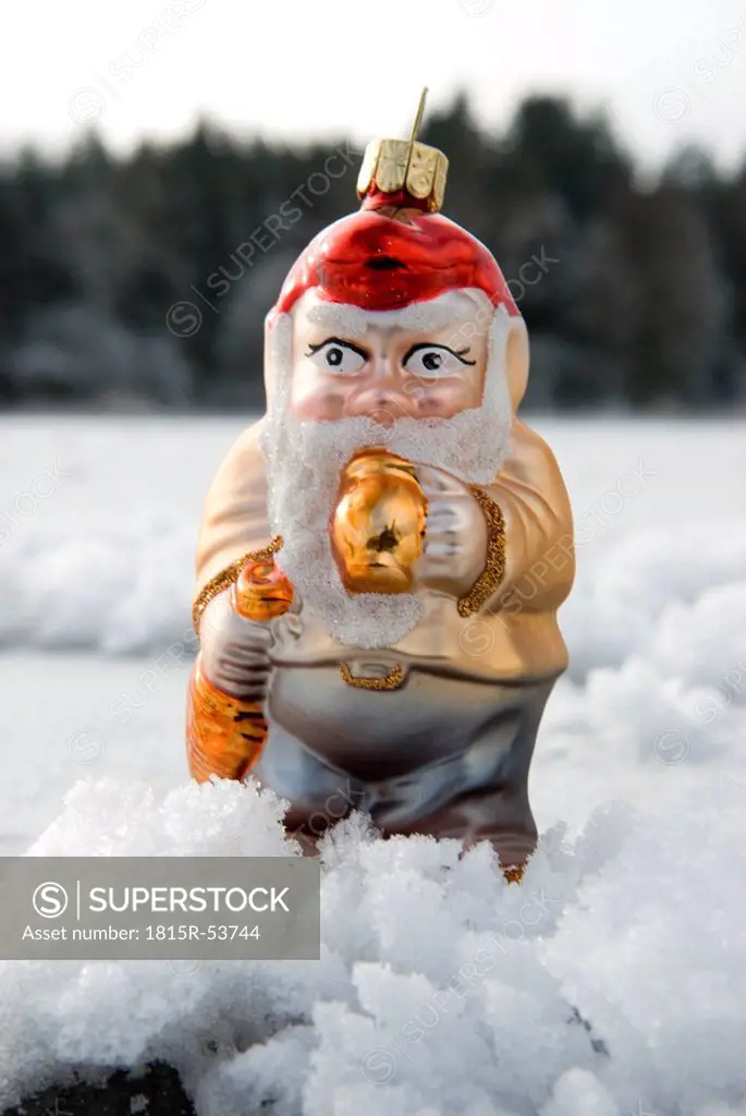 Christmans tree decorations, Garden gnome standing in snow, Close up