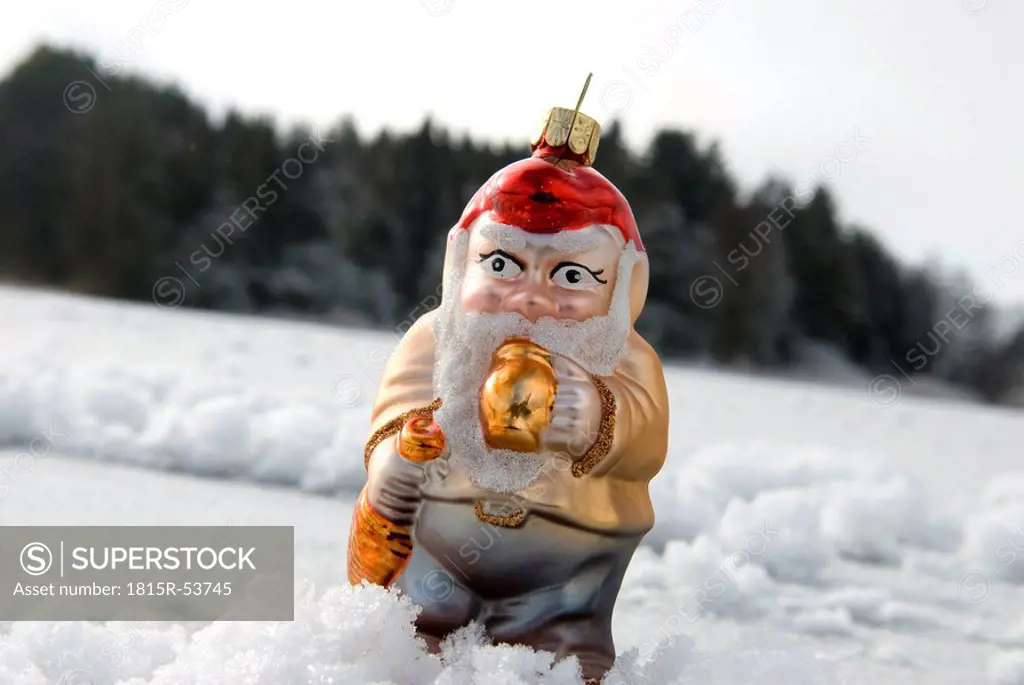 Christmas tree decorations, Garden gnome standing on snow, Close up