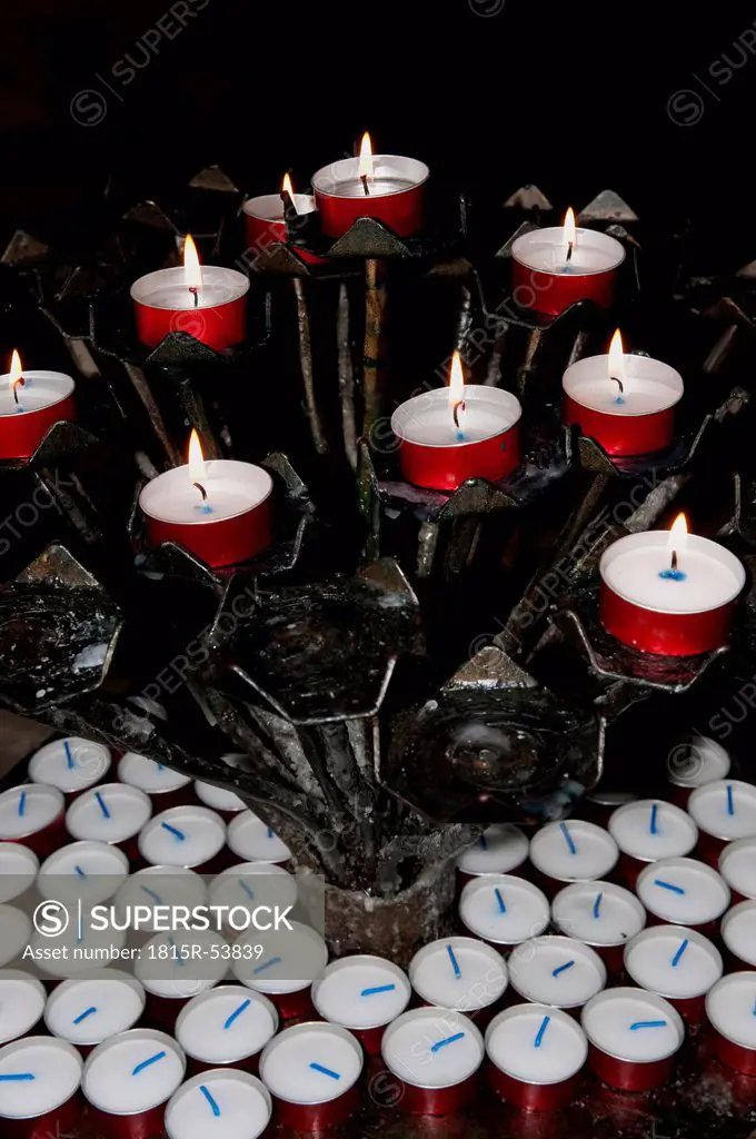 Italy, Venice, Lit candle lights in church, close_up