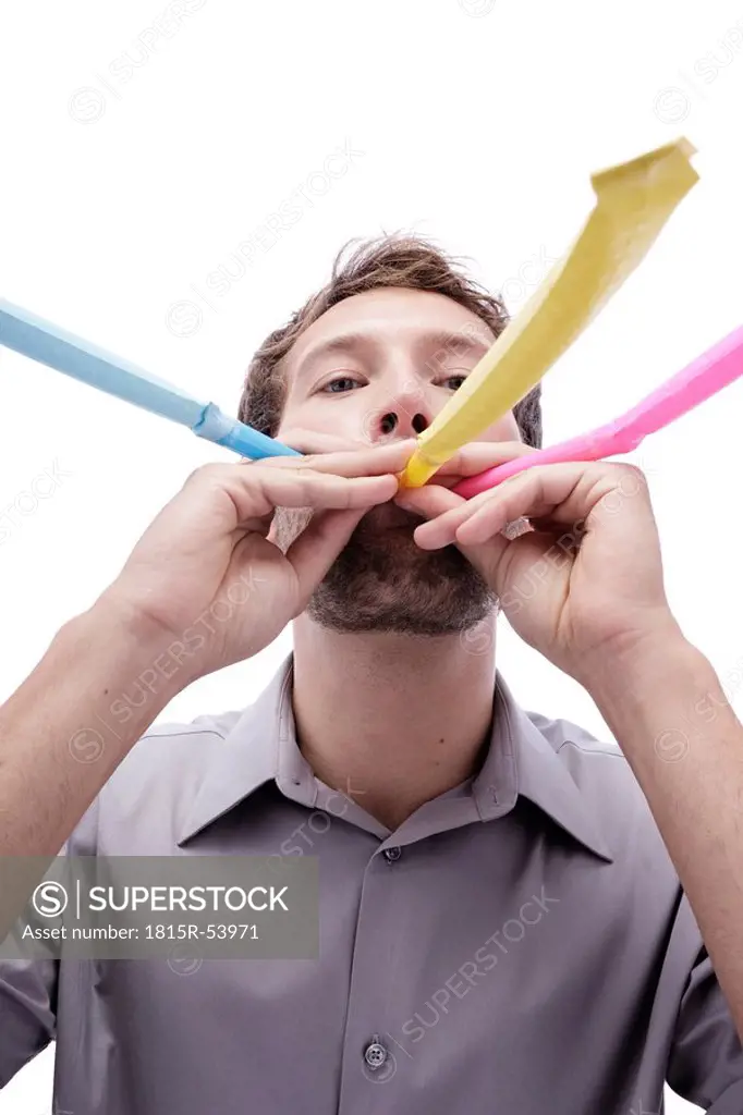 Young man with party blower in mouth, portrait,, close_up