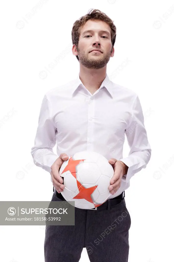 Young man holding soccer ball, portrait