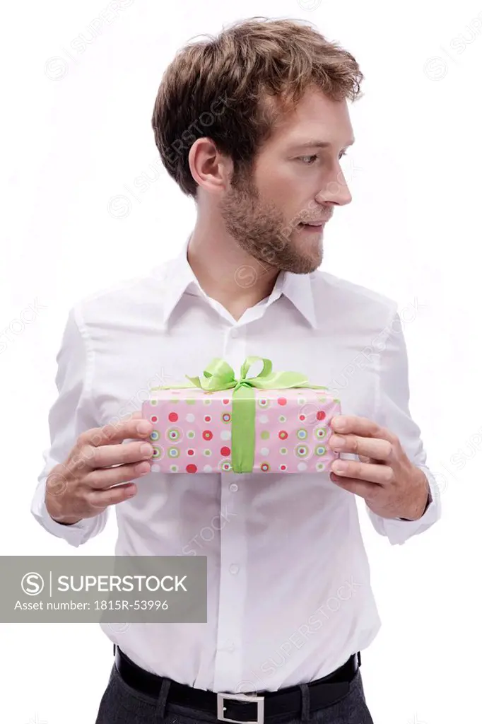 Young man holding gift box, portrait