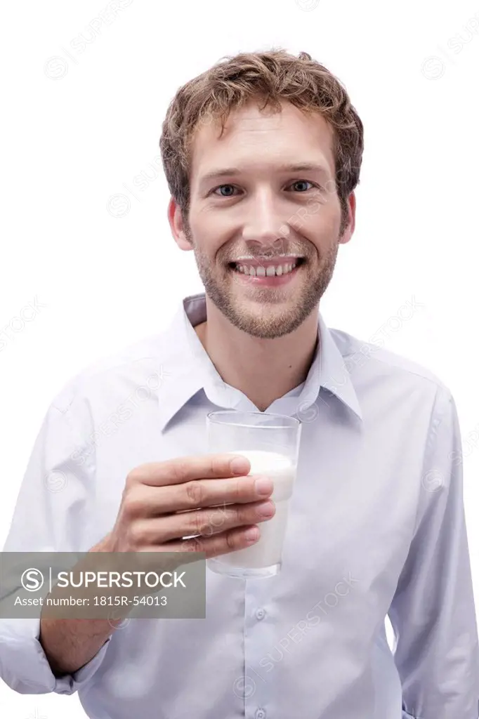 Young man holding a glass of milk, portrait