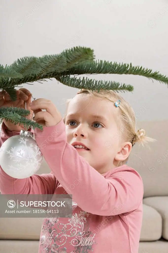 Little girl 3_4 holding Christmas bauble