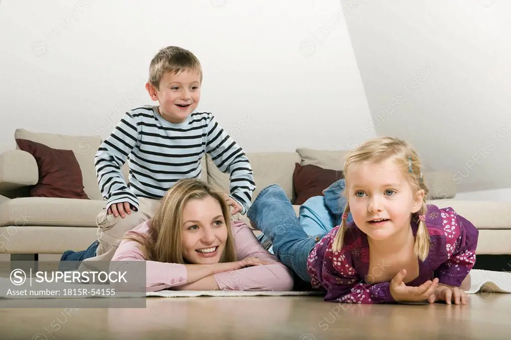 Mother and children relaxing at home, smiling