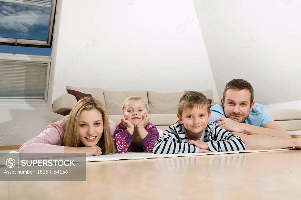 Family relaxing at home, smiling