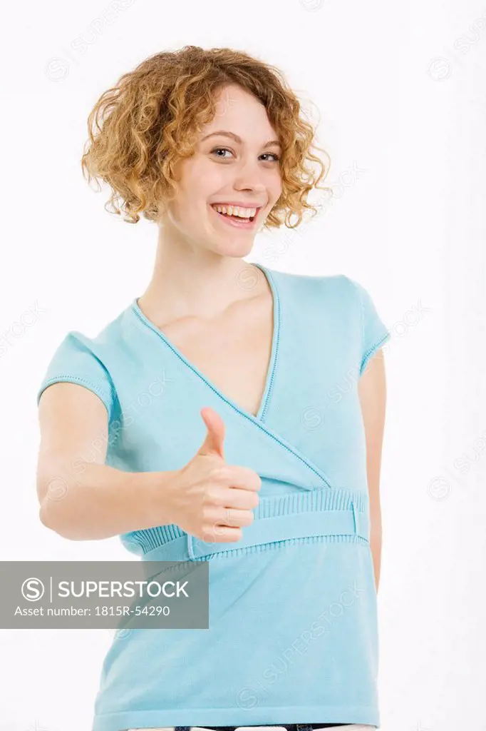 Young woman, thumbs up, smilling, portrait