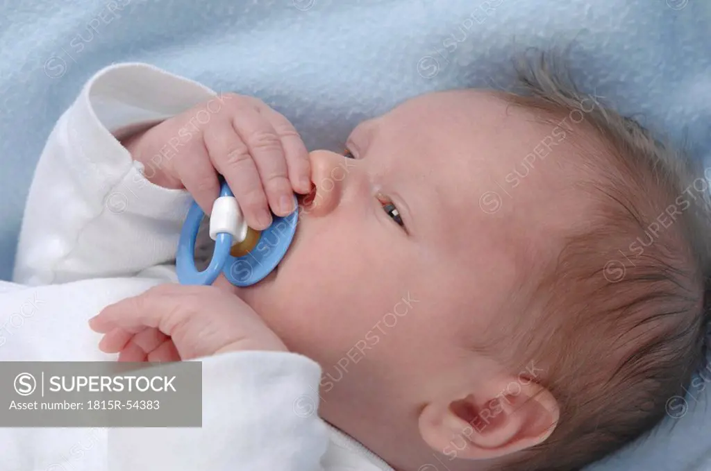 Germany, Bavaria, Munich, Baby boy 3 weeks, pacifier in mouth, close up