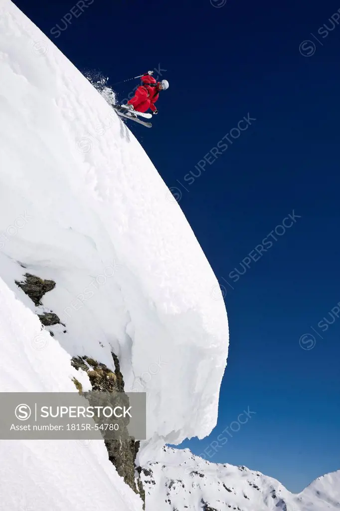 Austria, Salzburger Land, Gerlos, Skier jumping from Mountain, side view, elevated view