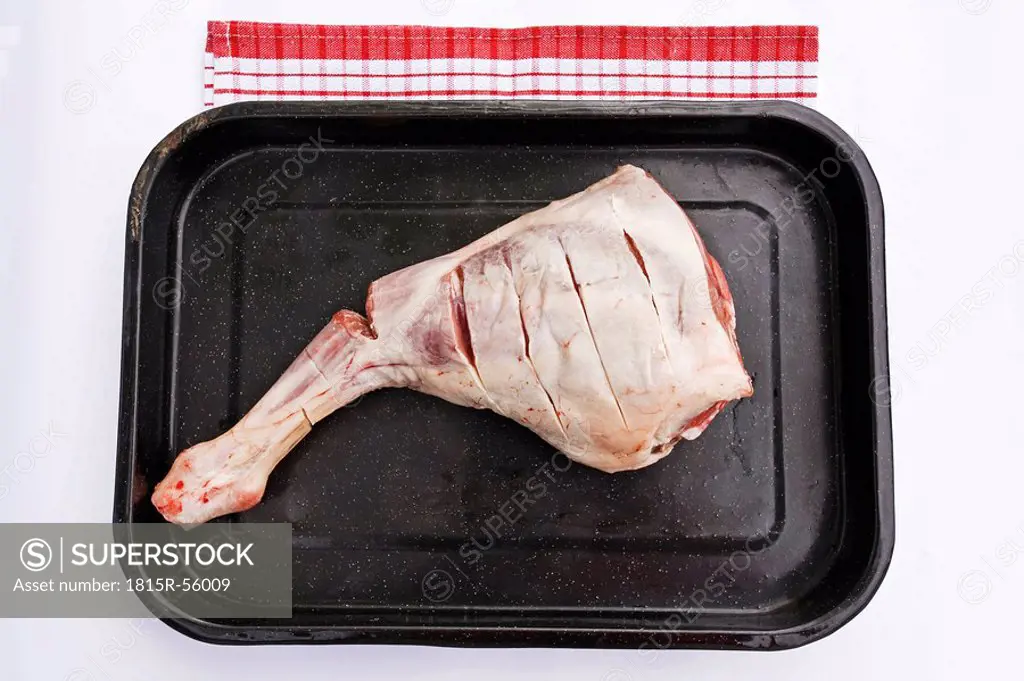 Raw Leg of lamb in roasting tray, elevated view