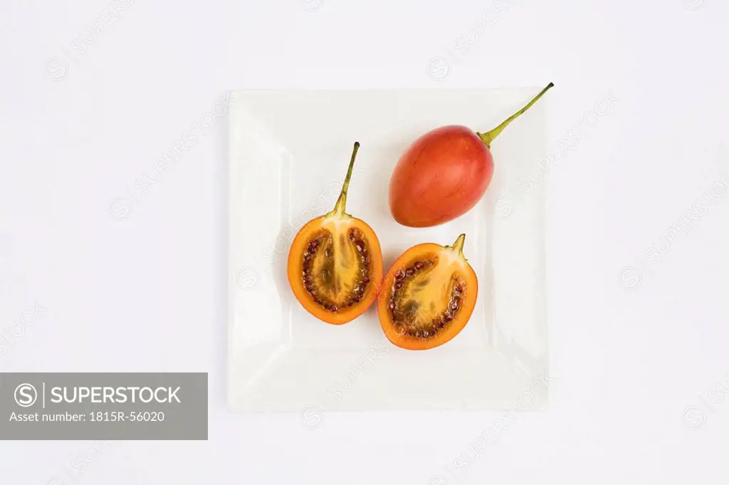 Sliced Tamarillos Solanum betaceum on plate, elevated view