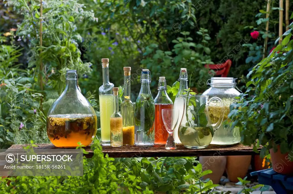 Austria, Salzbuger Land, Variety of bottles and carafes with vinegar and oil placed on side table