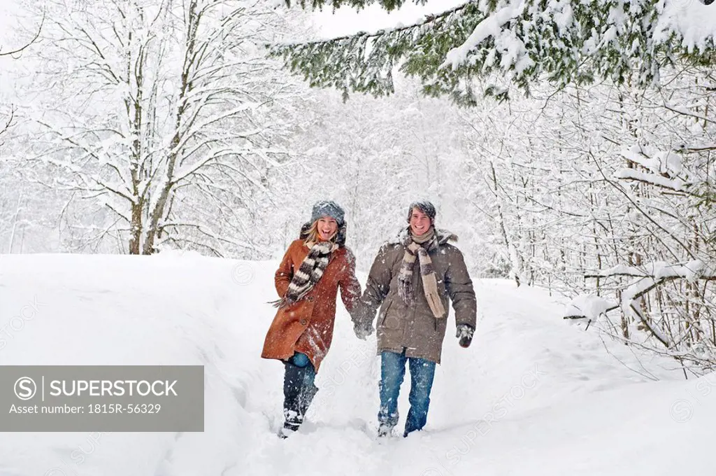 Austria, Salzburger Land, Altenmarkt, Couple walking in snow covered landscape