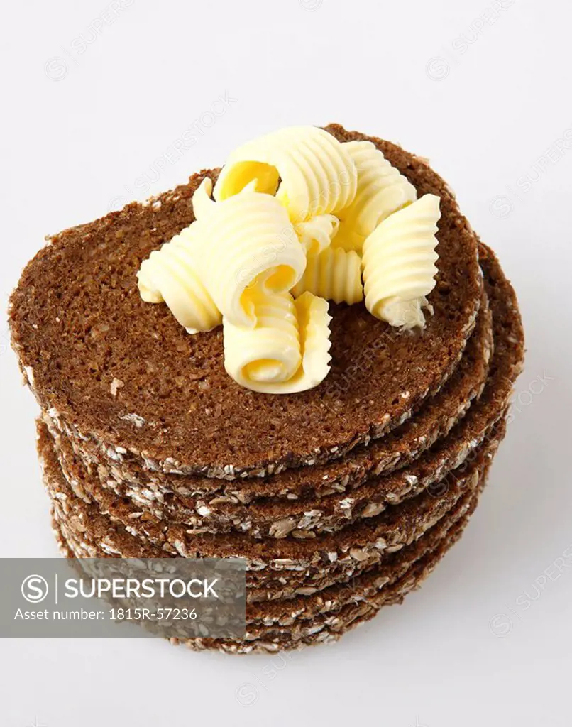 Stacked slices of brown bread with butter, elevated view