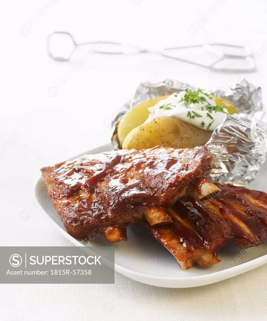 Barbecued Ribs with Baked potato on plate