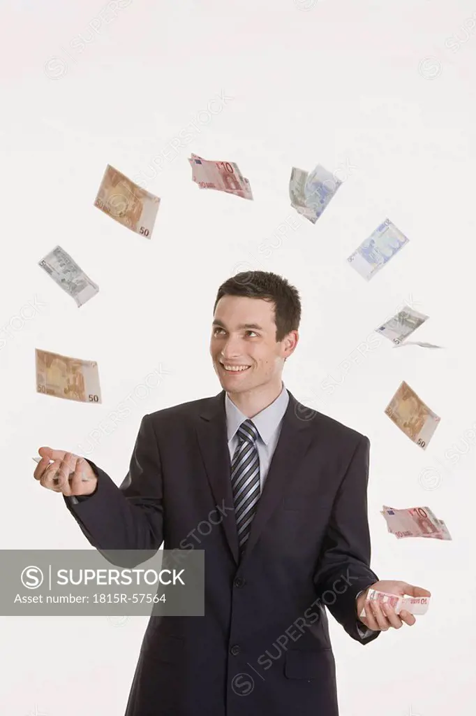 Businessman juggling Euro notes