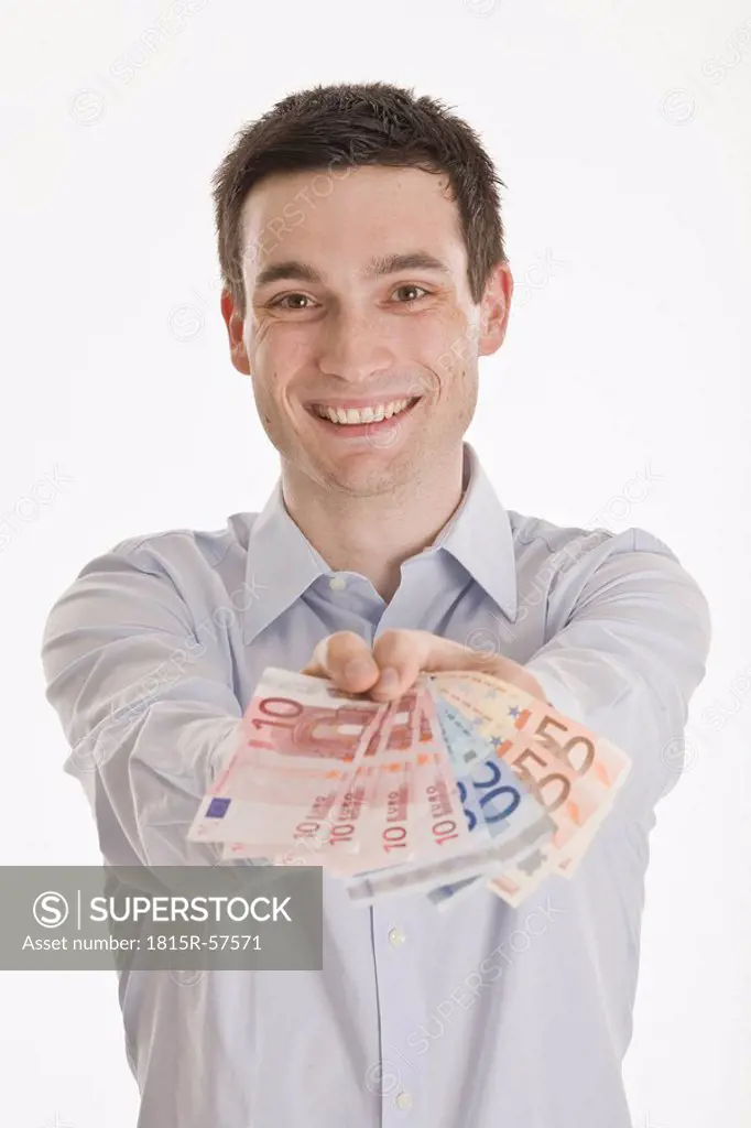 Businessman holding Euro notes, smiling, portrait