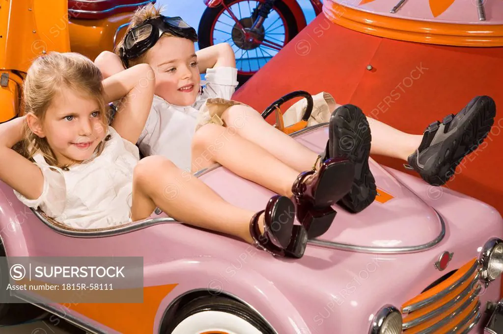 Germany, Landshut, boy and girl 4_5 sitting in carrousel car