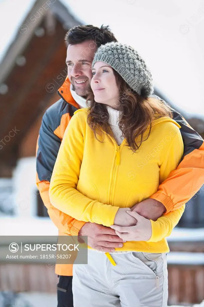 Germany, Bavaria, Couple in winter clothes, embracing