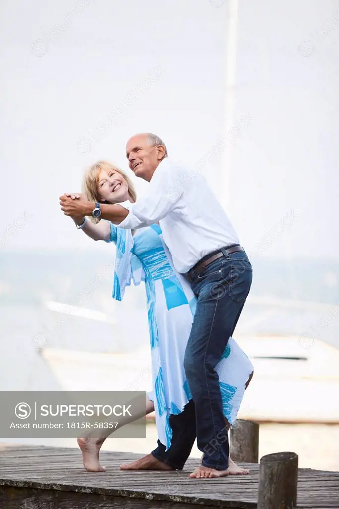 Germany, Bavaria, Starnberger See, Senior couple dancing on jetty