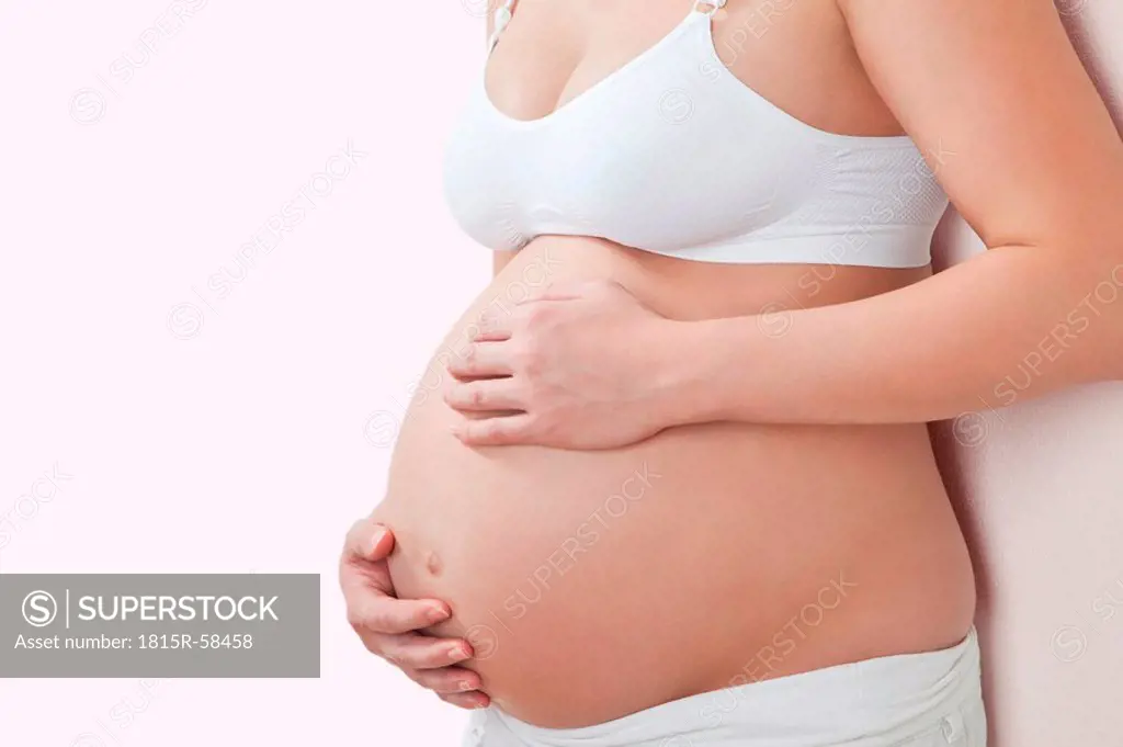 Woman´s hands holding pregnant belly