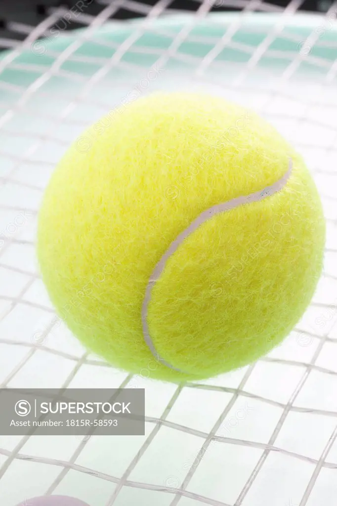 Tennis ball on racket, close_up