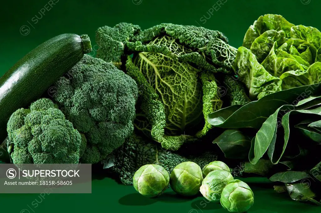 Raw vegetables against green background