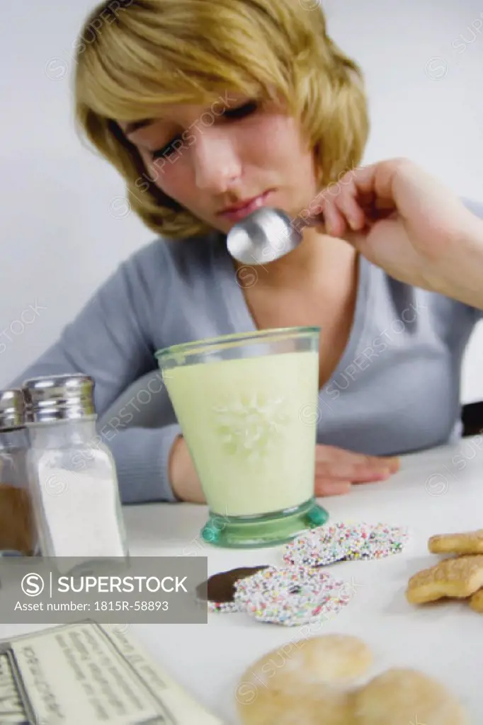 Young woman prepairing sweet milk