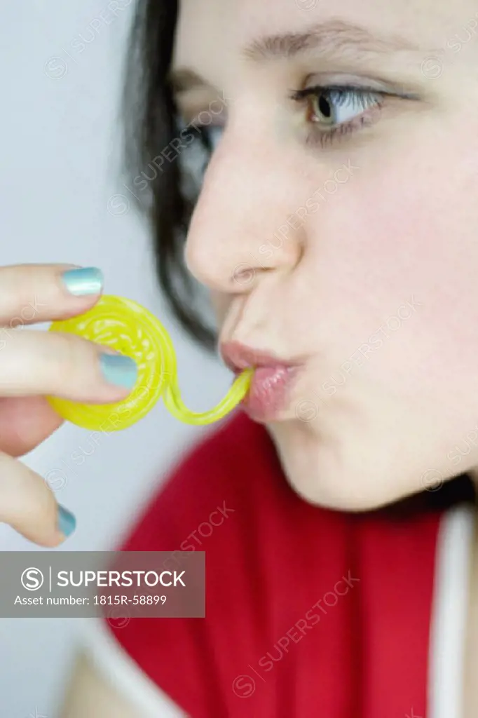 Young woman eating fruit jelly