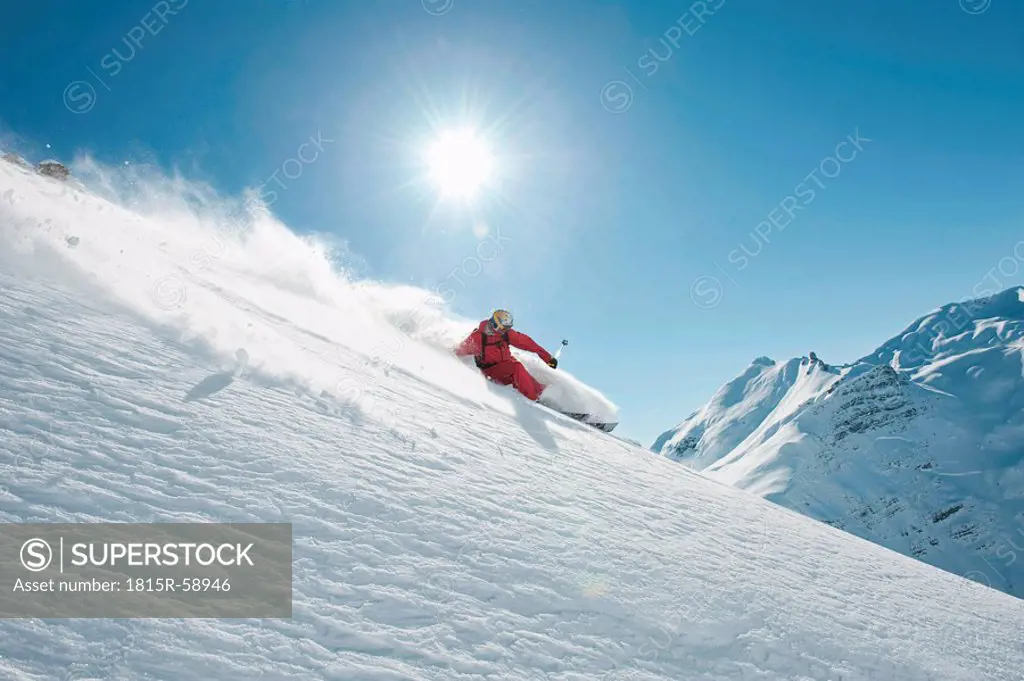 Austria, Arlberg. Man skiing downhill