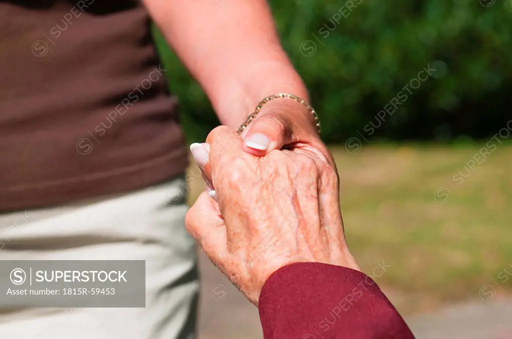 Senior women holding hands, close_up