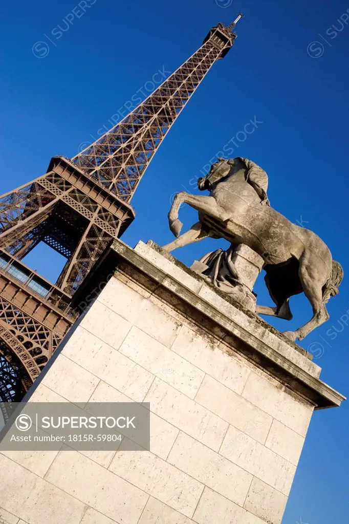 France, Paris, Eiffel Tower, Pont d´Lena, Statue in foreground, low angle view