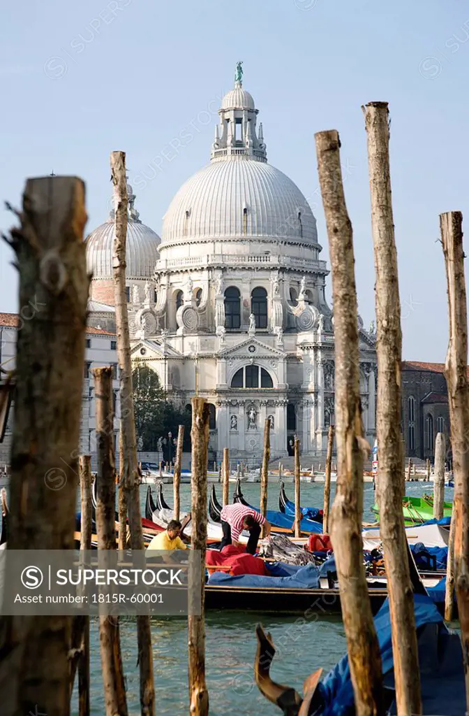 Italy, Venice, Gondolas parked along Grand Canal next to Santa Maria della Salute