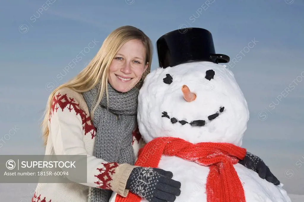 Germany, Bavaria, Munich, Woman hugging snowman