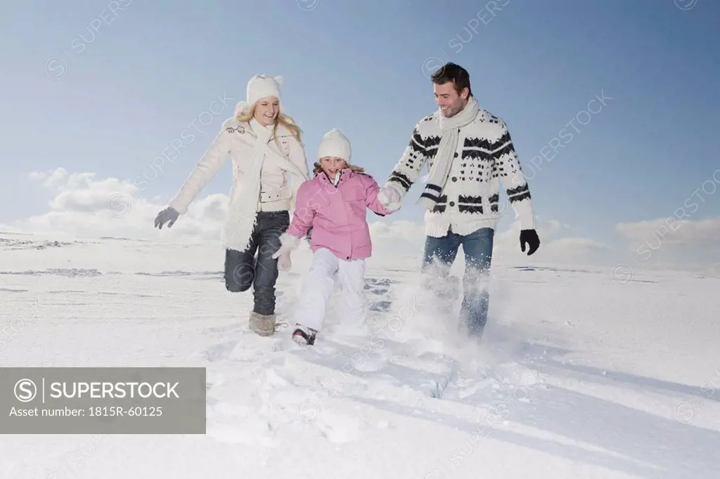 Germany, Bavaria, Munich, Family with daughter 6_7 in snowy landscape