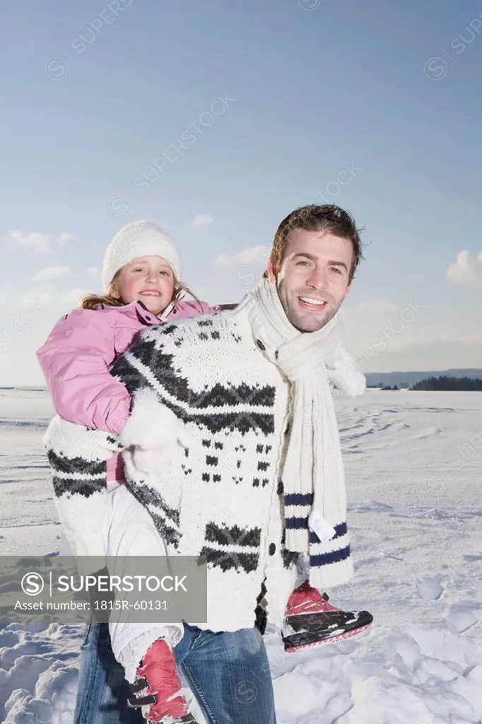Germany, Bavaria, Munich, Father carrying daughter 6_7, smiling, portrait