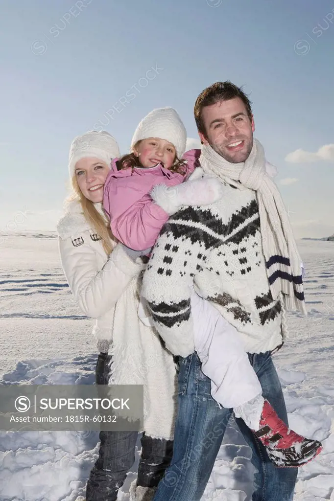 Germany, Bavaria, Munich, Family in snowy landscape, smiling, portrait
