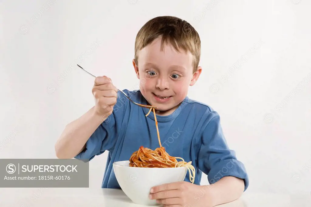 Boy 6_7 eating spaghetti, portrait